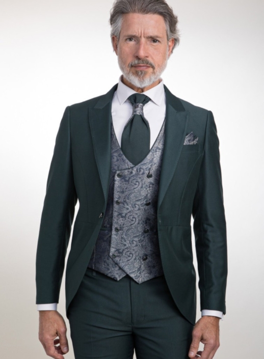 Traje verde oscuro semi-chaque corto, chaleco y corbatón, pantalón liso. Camisa a elegir por el cliente
